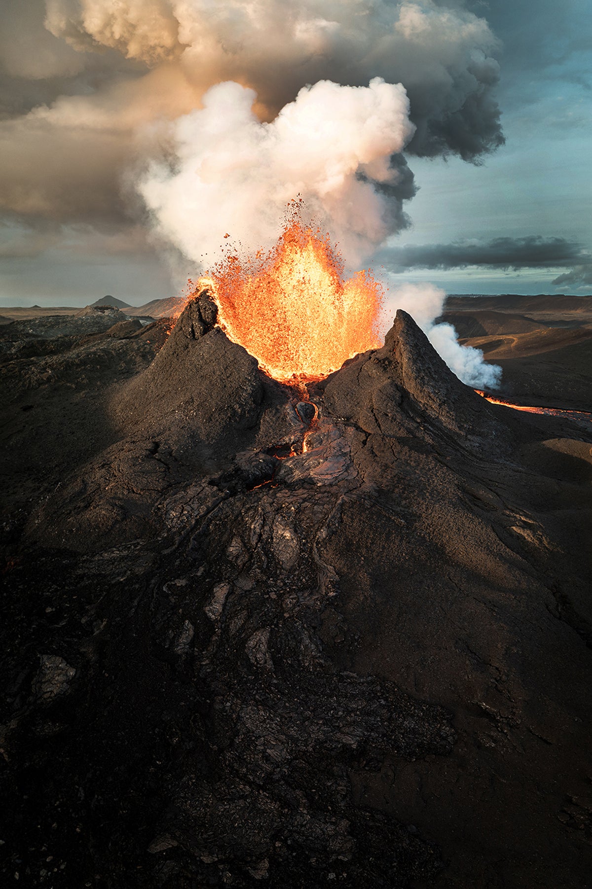 Lava exploding from the crater of a volcano.