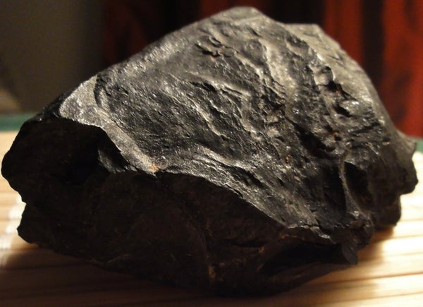 Image is a close-up view of a lump of black anthracite coal from Black Mesa Mine, Arizona.