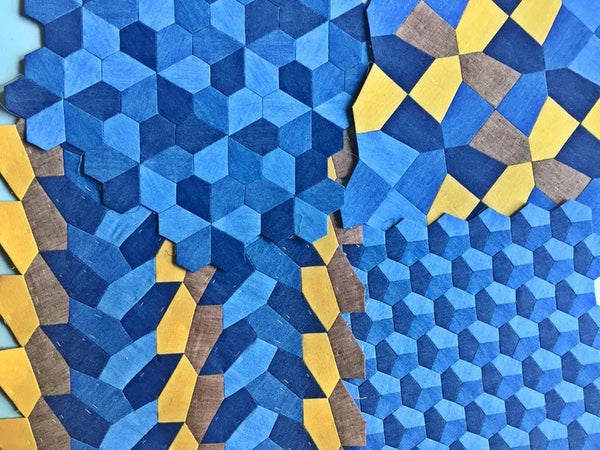 Tilings of the plane by pentagons in blue, yellow, and gray-brown fabric