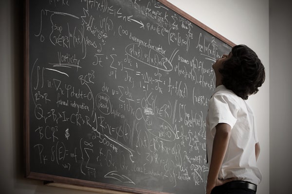 A child looks up at a blackboard filled with math notation