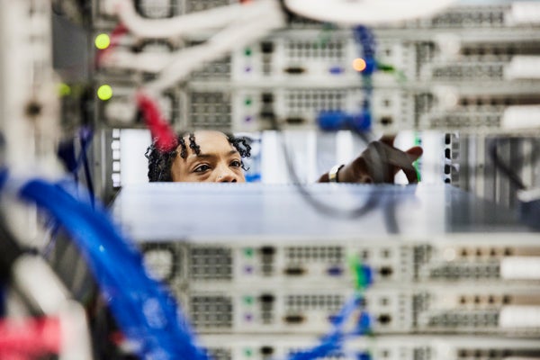 Female IT professional working in data center