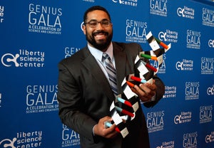 John Urschel attends Liberty Science Center’s Genius Gala 4.0 and holds a replica of DNA.