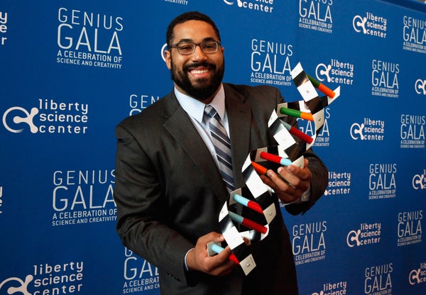 John Urschel attends Liberty Science Center’s Genius Gala 4.0 and holds a replica of DNA.