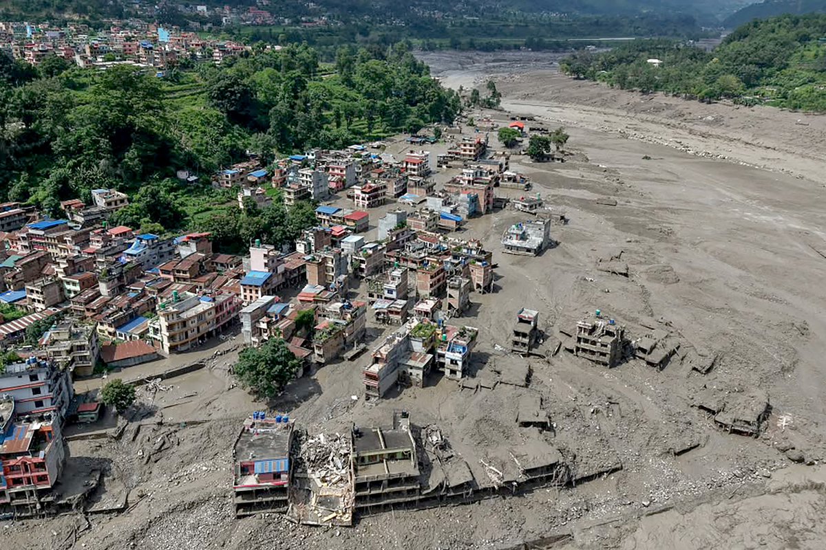Wall of floodwater sweeps away villages in Nepal, with hundreds missing