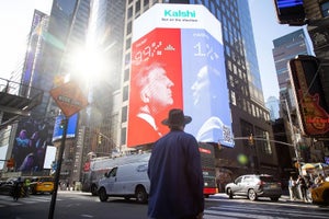A billboard for Kalshi in Times Square, New York City, showing 2024 US presidential-election odds with images of Trump and Harris facing off.