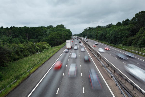 Cars on a highway seen from an oblique angle and blurred by motion