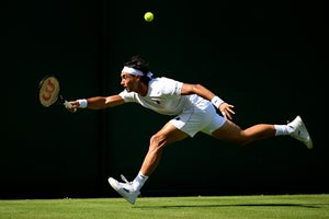 Thiago Agustin Tirante of Argentina plays a forehand against Fabian Marozsan of Hungary during the Gentlemen's Singles first round match on day one of The Championships Wimbledon 2026