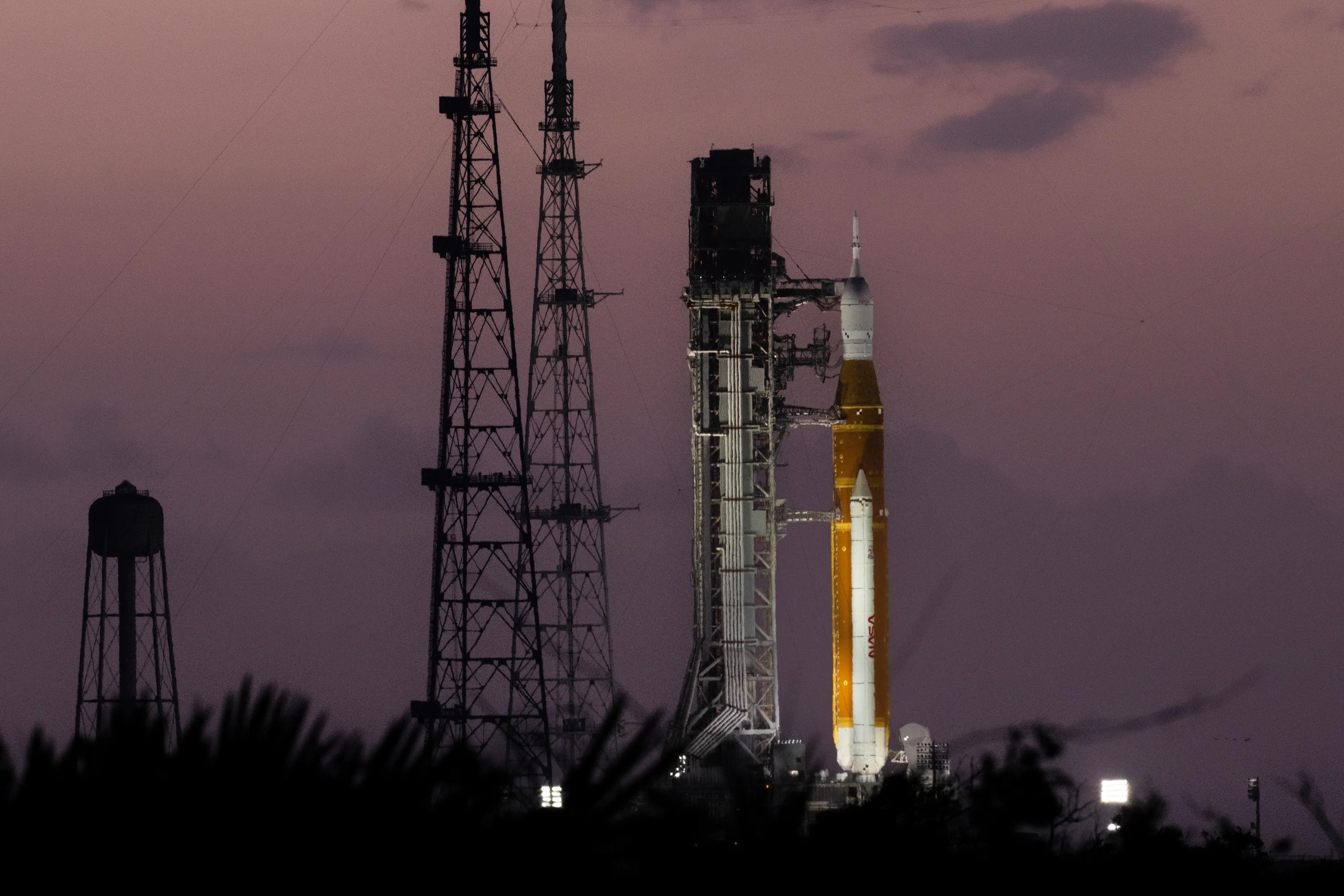 The Artemis II rocket on the launchpad at dusk.