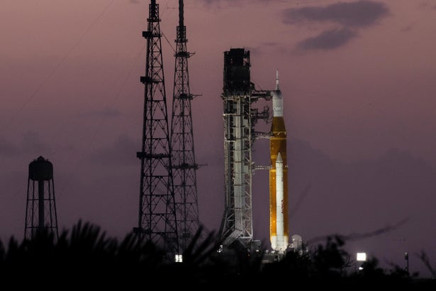 The Artemis II rocket on the launchpad at dusk.