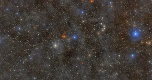 A dark sky filled with millions of pinpricks of light representing stars and galaxies.