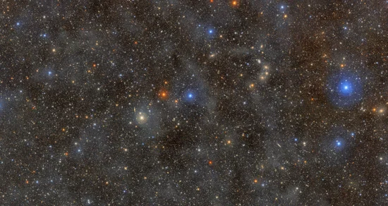 A dark sky filled with millions of pinpricks of light representing stars and galaxies.