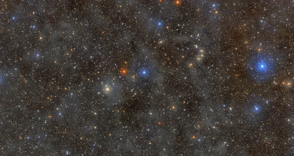 A dark sky filled with millions of pinpricks of light representing stars and galaxies.