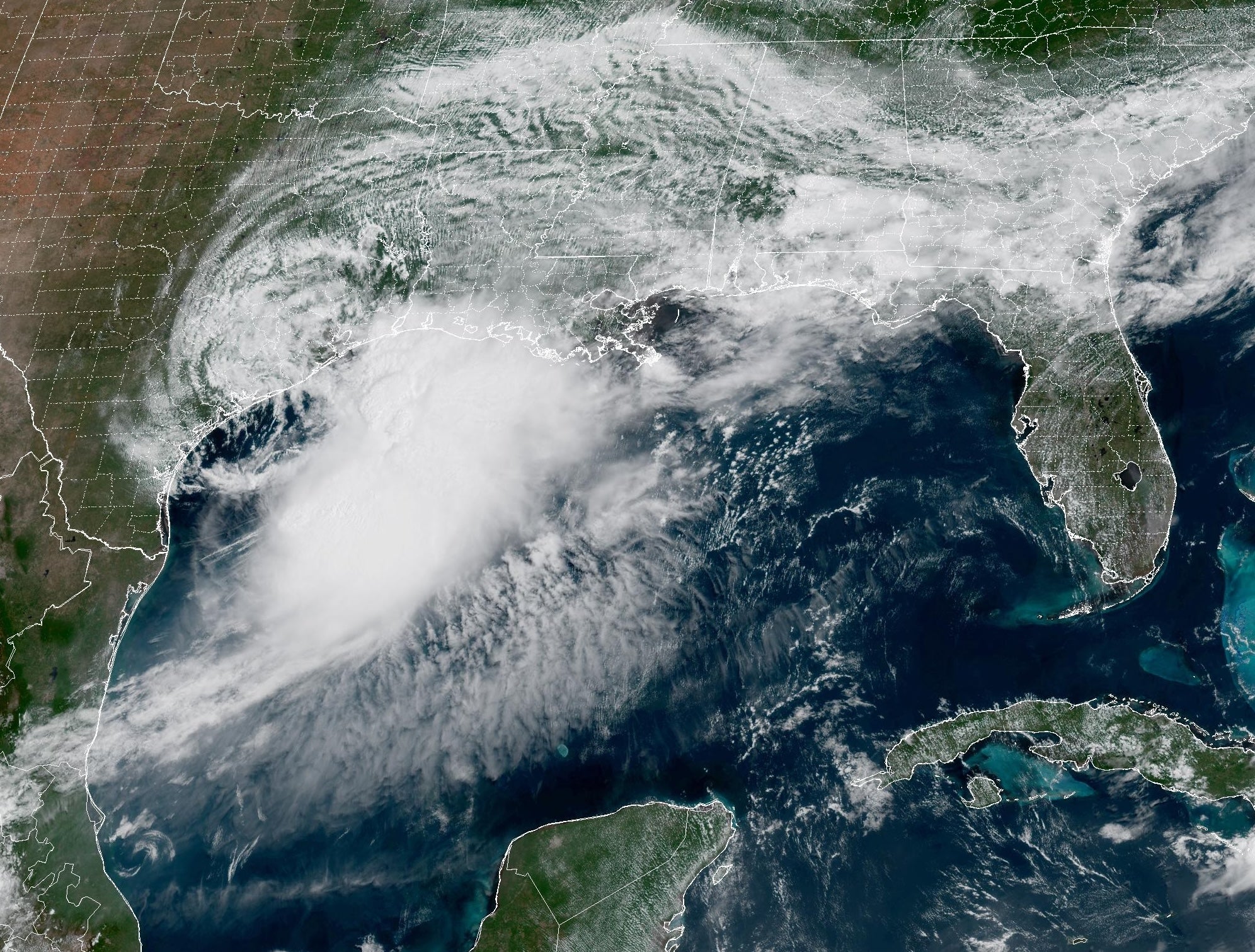 A cluster of clouds over the Gulf Coast of Texas, with more scattered clouds visible across the southeast.