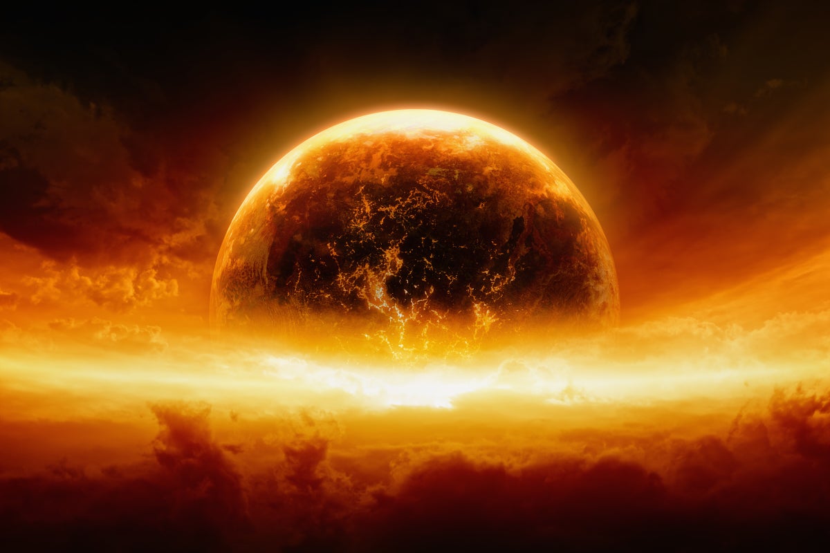 Abstract apocalyptic background showing a burning and exploding planet Earth in an orange-red sky.