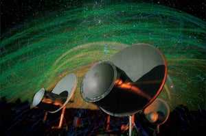 A radio telescope with a starry background.
