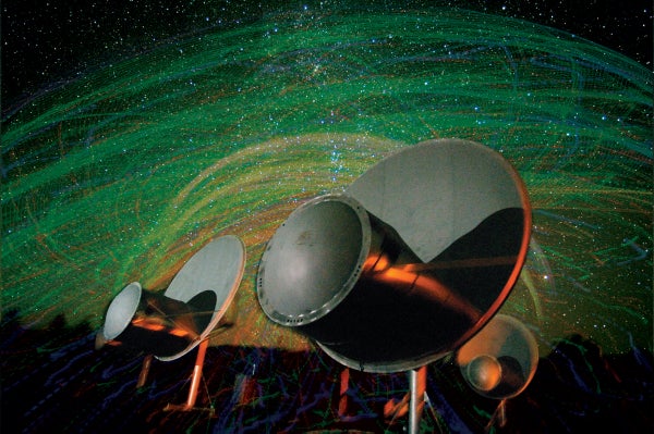 A radio telescope with a starry background.