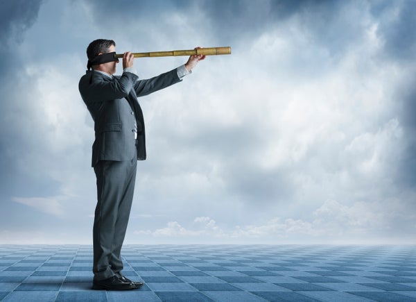 A blindfolded man seen in profile attempts to gaze into the distance through a spyglass. Ominous clouds fill the background.