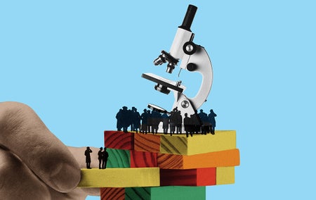 Conceptual art illustrating the state of American science. A large hand removes bricks from a Jenga-style tower supporting individuals and a microscope.