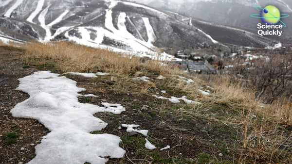 Illustration of a small patch of snow on the ground against a hilly backdrop