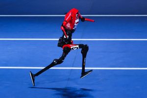 Humanoid robot runs on track.