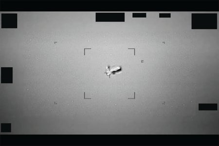 Black-and-white image of a football-shaped object in the sky spotted near Japan