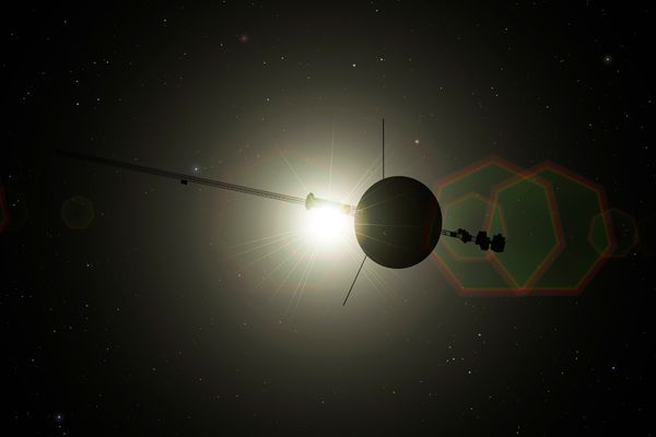 An illustration of the Voyager spacecraft leaving the solar system. The spacecraft is in silhouette with the light from the distant sun shining through.
