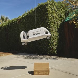 Zipline provided photo of its home delivery drone dropping a package in a residential backyard.