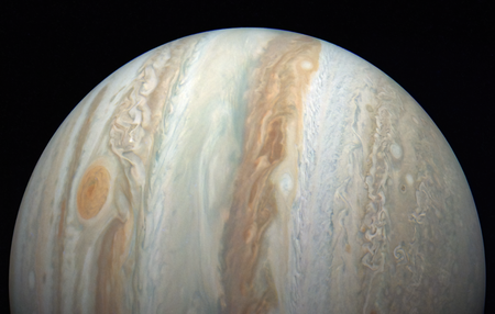 An image of half of Jupiter's disk turned on its side, with its distinctive stripes running vertically and the Great Red Spot to the left.