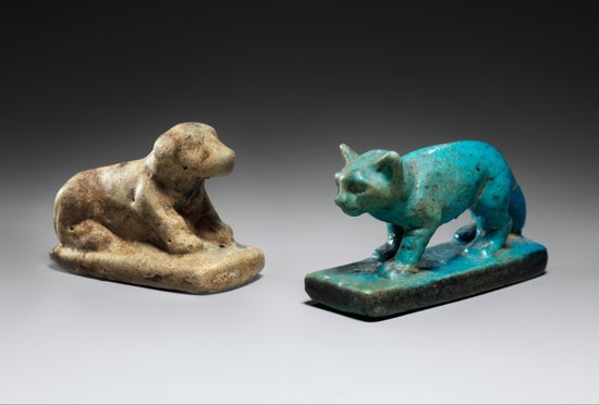 A stone figure of a dog and a cat.