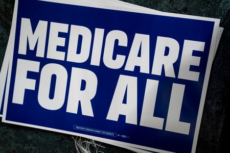 A “Medicare for All” sign captured before Michigan Democratic candidate for Senate Abdul El-Sayed spoke at the People v. the Powerful rally at the Detroit Opera House on July 18, 2026.