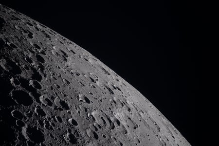 A view of the lunar surface showing craters in sharp relief.