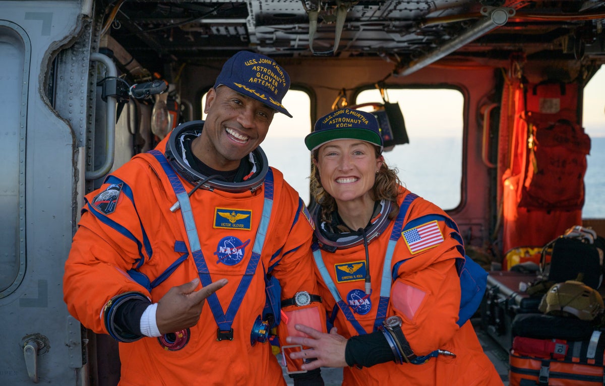 Two Artemis II astronauts, NASA's Victor Glover and Christina Koch, pose together onboard the USS John P. Murtha after a successful splashdown.