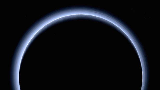 Pluto appears as a blue-silhouetted dark orb in this picture from NASA's New Horizons probe.