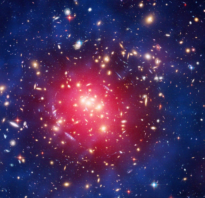 This image features ZwCl 0024+1652, an immense and distant cluster of galaxies bound together by gravity.