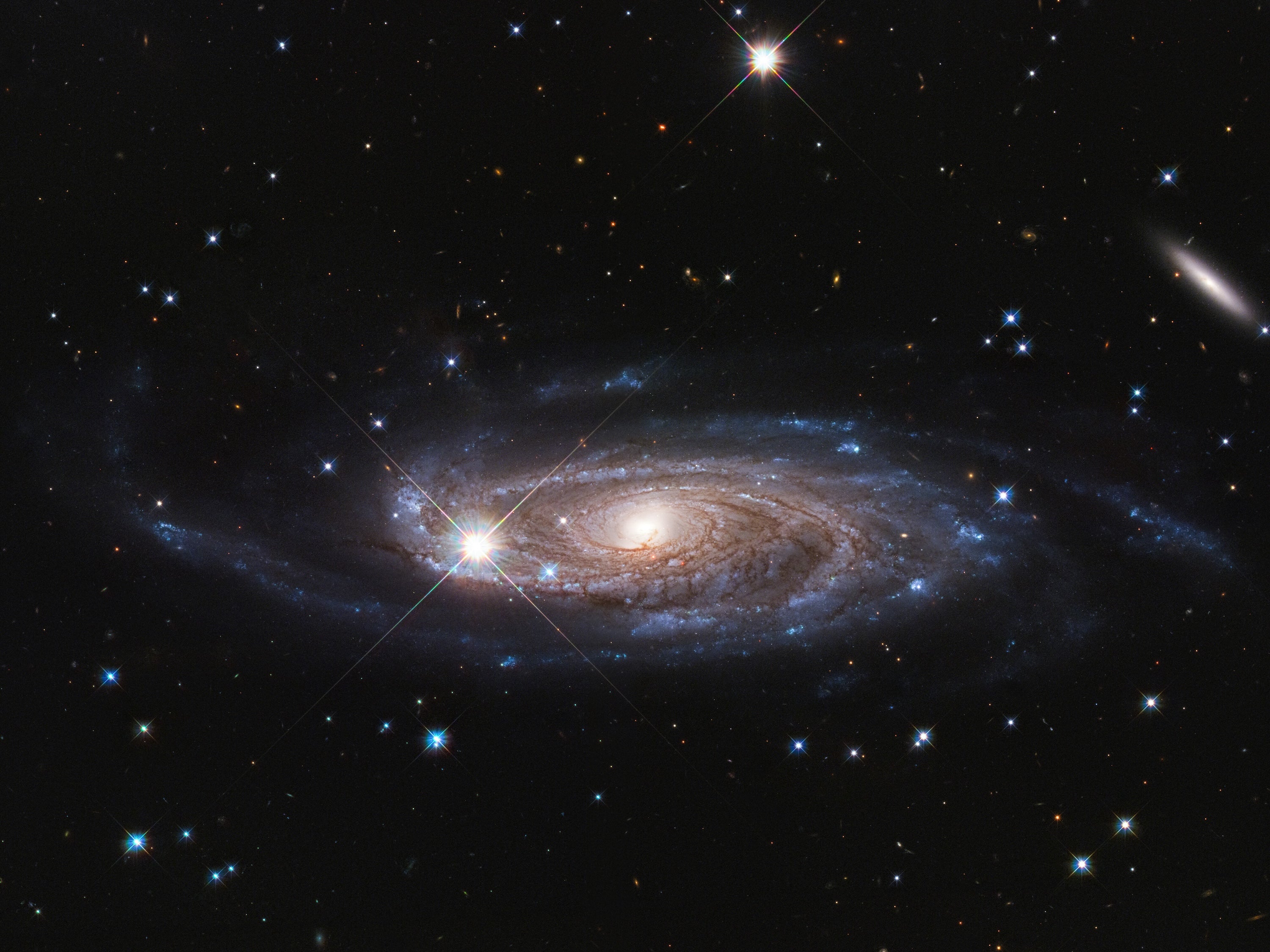 A photograph of a giant spiral galaxy in deep space