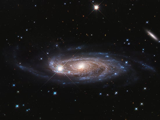 A photograph of a giant spiral galaxy in deep space