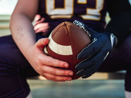 A child holding an American football