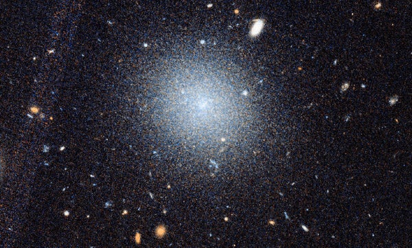 A close-up Hubble image of DF9 is shown beneath a wider view of the surrounding NGC 1052 region. Blue boxes highlight a line of related galaxies, including DF2 and DF4. Red outlines show where Keck Observatory’s KCWI instrument collected data, while yellow circles mark galaxy clusters whose motions have already been measured. Both images are oriented along the direction of the galactic structure.