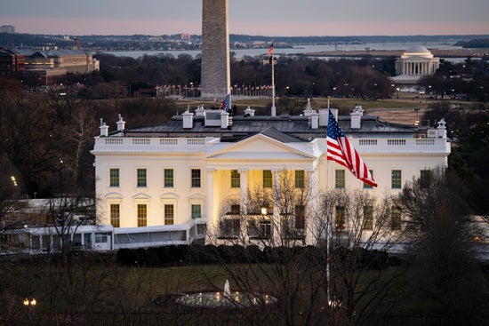 Long shot of the White House with the Thomas Jefferson Memorial visible behind it.