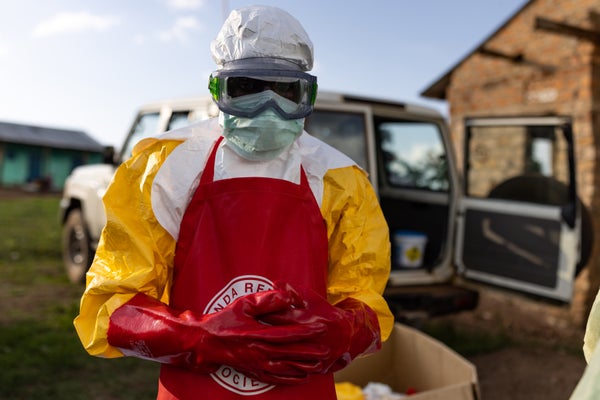 Ugandan Red Cross workers put on PPE prior to a Safe and Dignified Burial on October 11, 2022 in Mubende, Uganda.