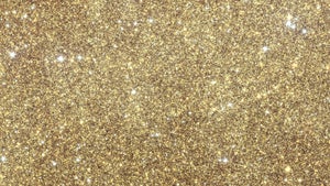 A field of stars and other objects picked out in gold and purple