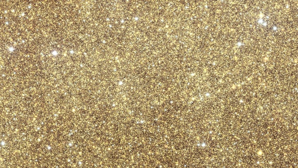 A field of stars and other objects picked out in gold and purple