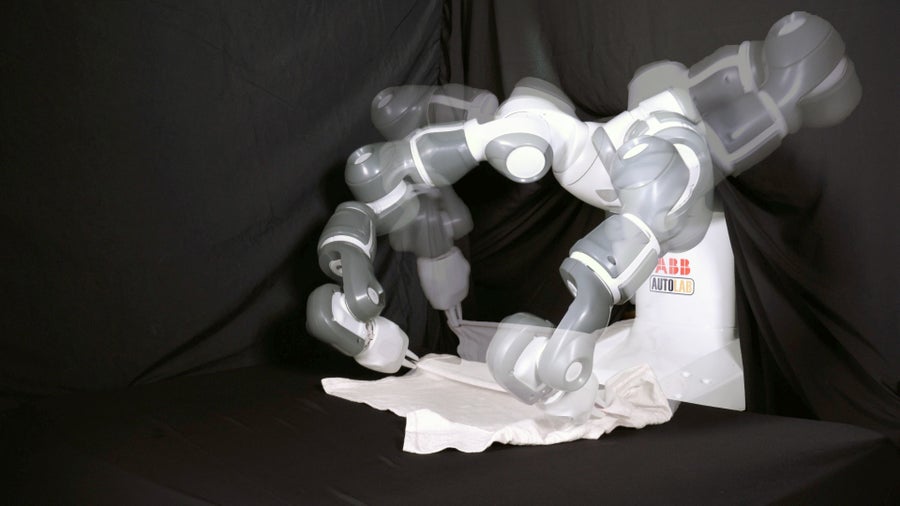 Robotic hand against a black sheet.