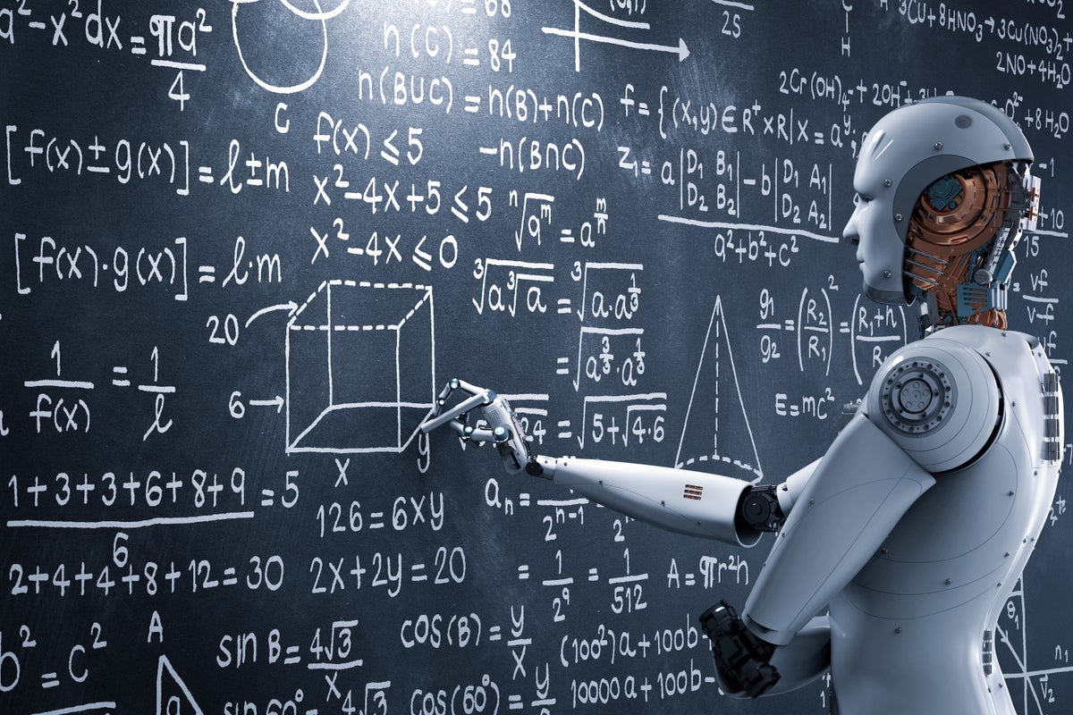A humanoid robot holding a piece of chalk draws on an equation- and figure-filled blackboard.