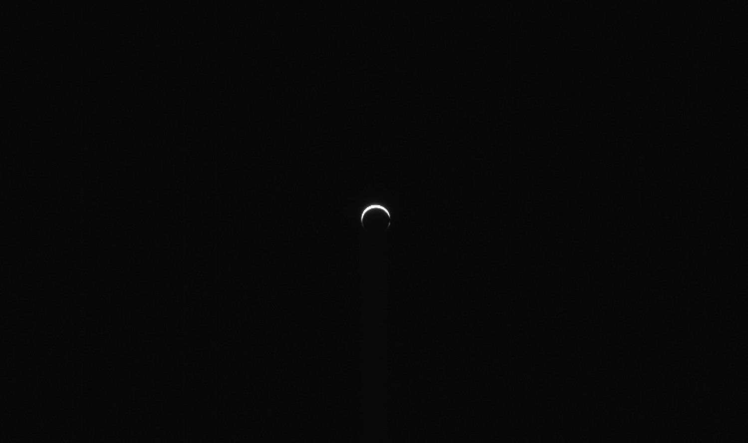 A small bright crescent against blackness.