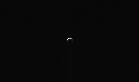 A small bright crescent against blackness.
