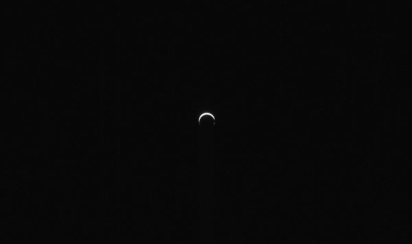 A small bright crescent against blackness.