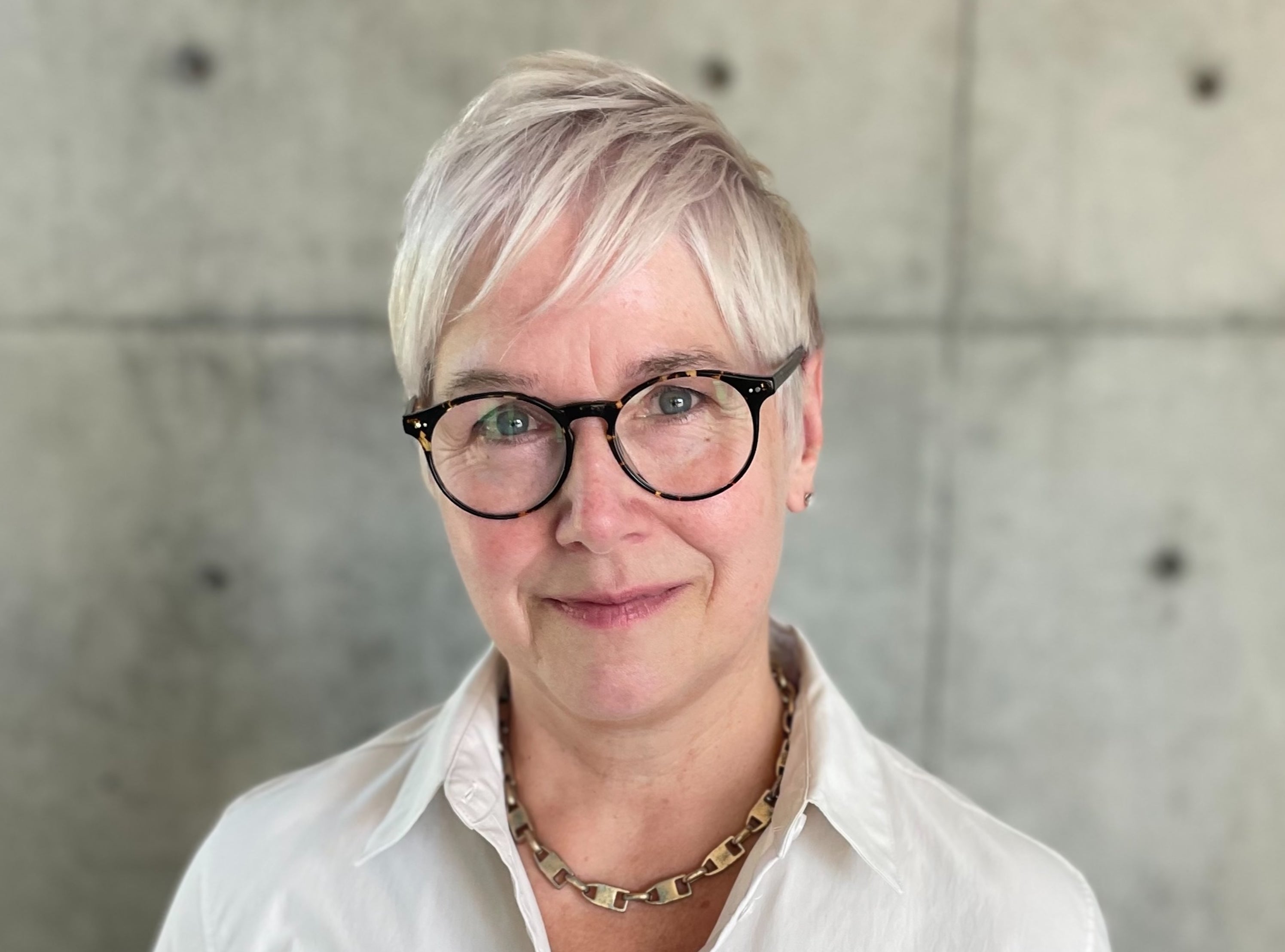 Headshot-style photo of the planetary scientist Lindy Elkins-Tanton wearing a white collared shirt.