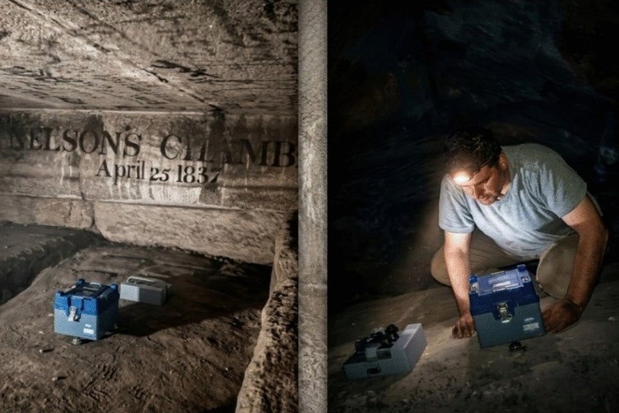 Person taking measurements in dark chamber.