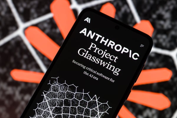 A close-up of a smartphone screen displaying the text 'Anthropic Project Glasswing' and 'Securing critical software for the AI era' over a geometric pattern, set against a blurred orange and black background.